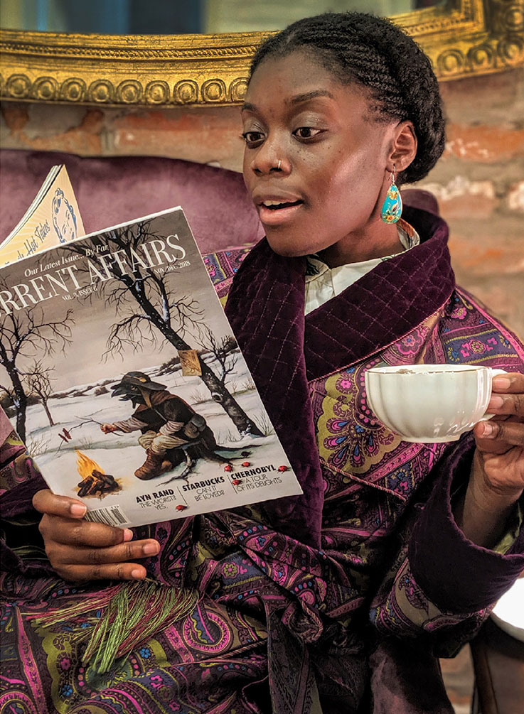 Staffer in luxury robe reading the magazine